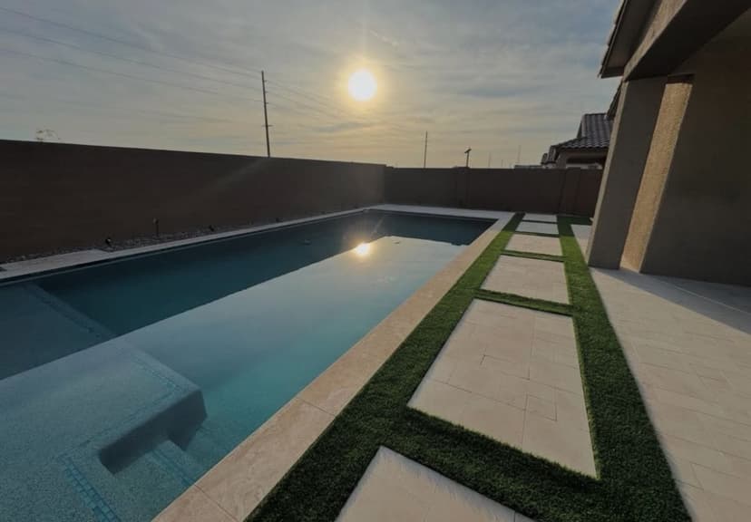 Long geometric pool with a baja shelf and linear stepping-stone deck