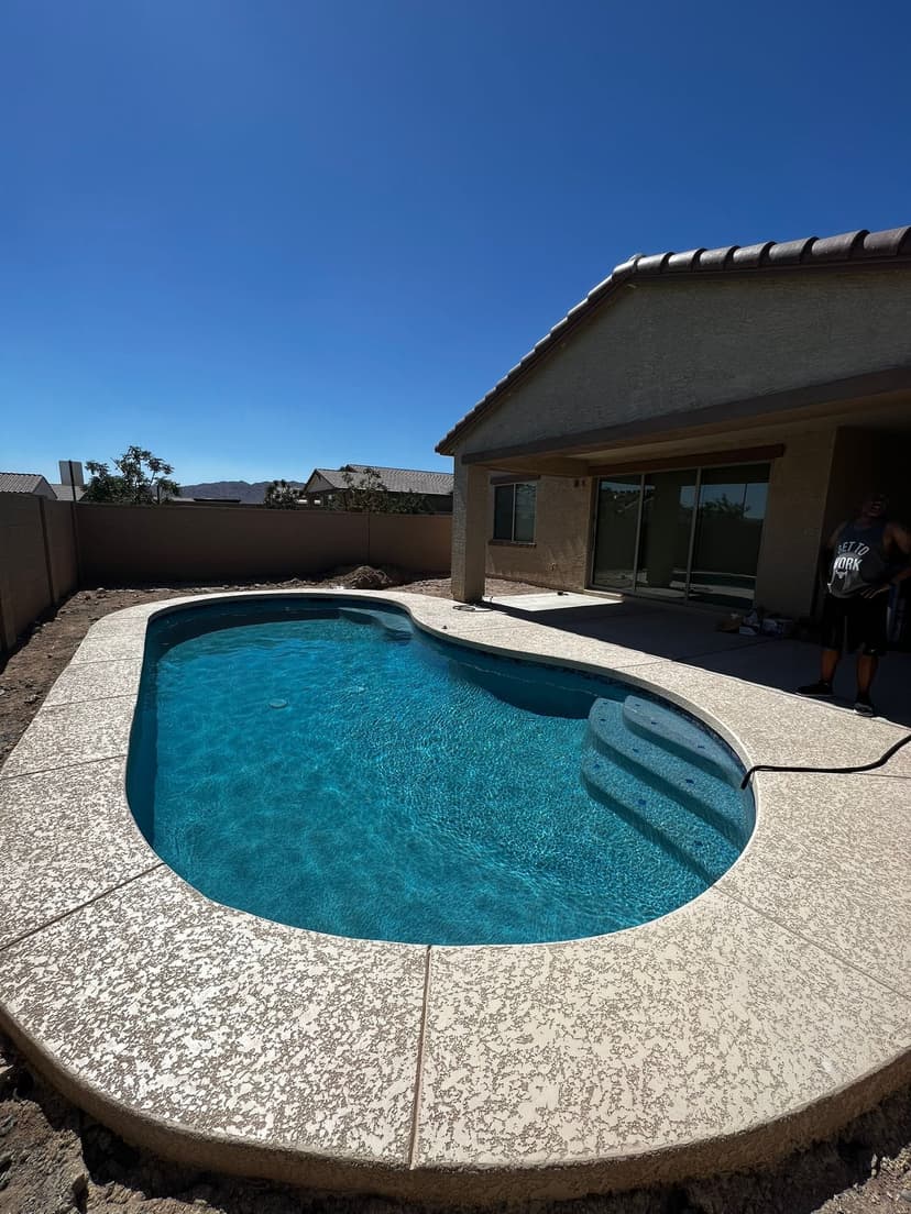 Lagoon-style pool with rock features, real project